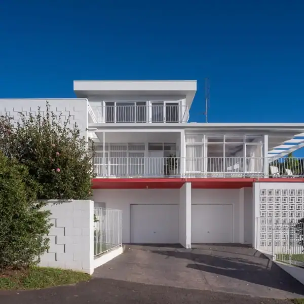 modern coastal home facade with integrated double garage and white brickwork