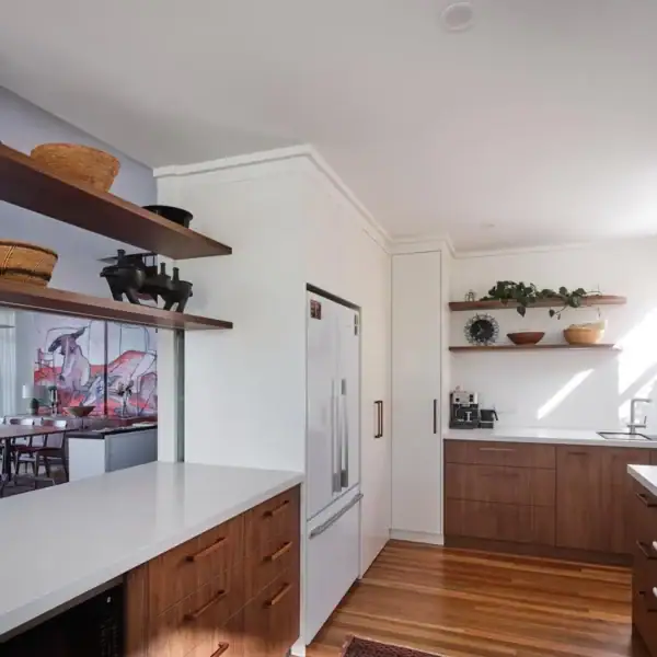 bespoke timber kitchen joinery with integrated shelving and stone benchtops
