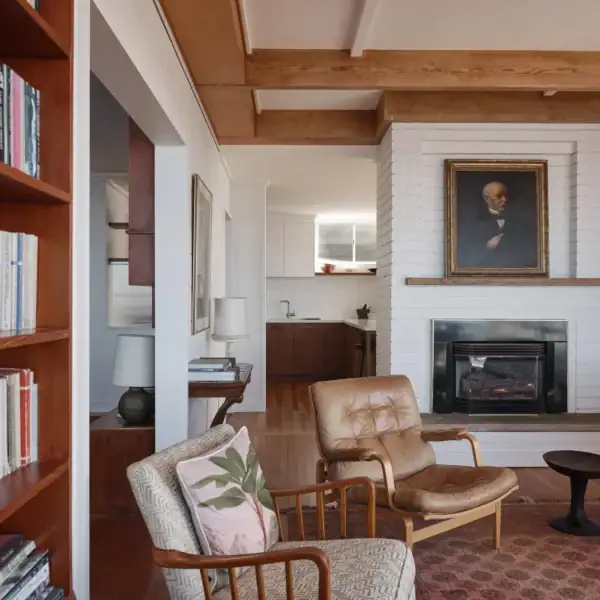 mid century modern living room with white brick fireplace and timber ceiling