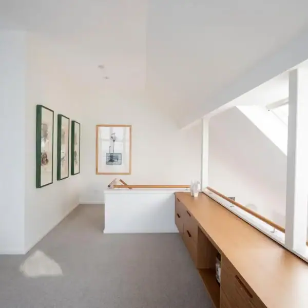 Architectural hallway with custom timber cabinetry and skylights in a coastal home by Simpson and Co Projects.