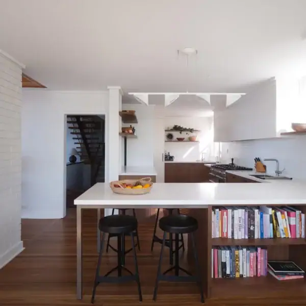 modern coastal kitchen with white stone island bench and timber cabinetry