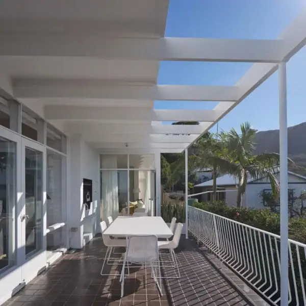 architectural outdoor entertainment terrace with white pergola and mountain views