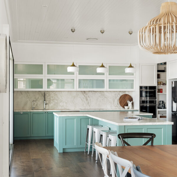 Coastal kitchen with mint cabinetry, marble splashback, pendant lighting and custom joinery at Wombarra No. 3.