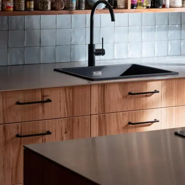 matte black kitchen sink and tapware with blue handmade tiles and timber cabinetry Austinmer