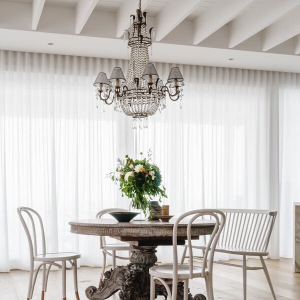 Austinmer coastal home dining area with chandelier and timber table
