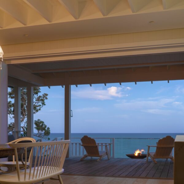 Austinmer coastal home outdoor deck with firepit and ocean view at dusk