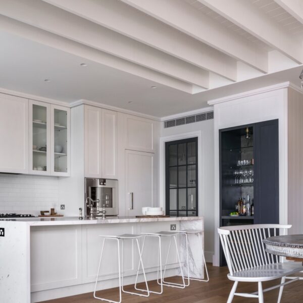 Austinmer coastal home kitchen opening to living area with island bench