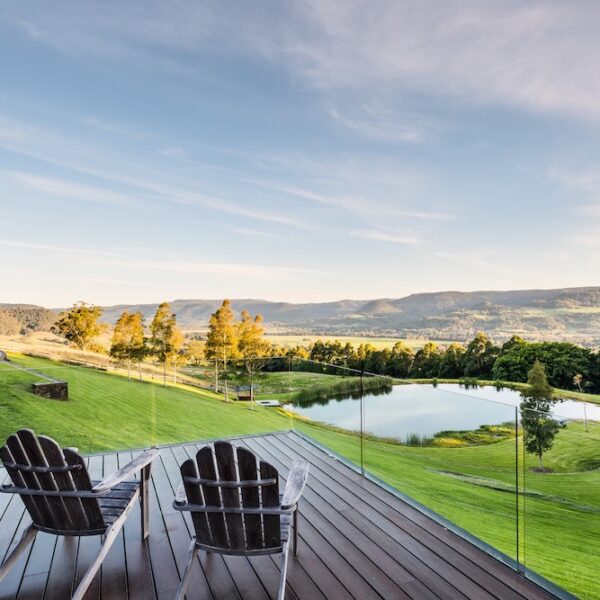 Outdoor deck at Ooralba Estate overlooking rolling hills, lake views, and landscaped grounds in Kangaroo Valley, built by Simpson & Co to the architect’s design.