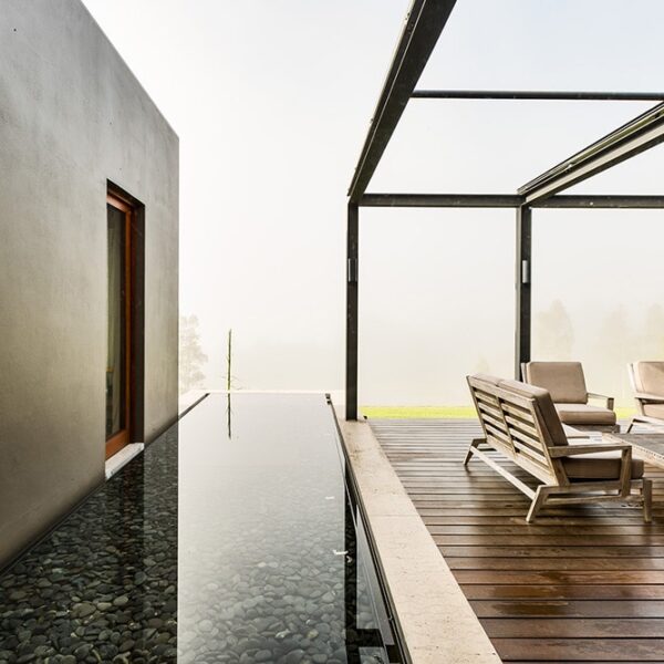 Architect-designed outdoor dining terrace at Ooralba Estate featuring timber structure, open pergola, and valley views, built by Simpson & Co in Kangaroo Valley.