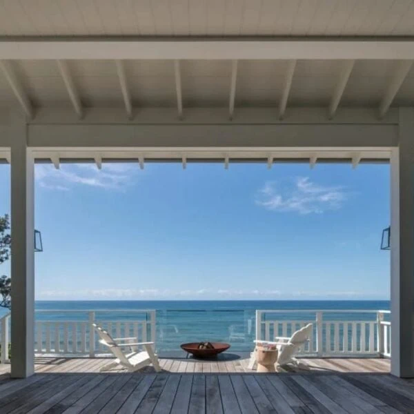 Panoramic ocean view from a custom architectural deck with high-performance coastal finishes in Austinmer by Simpson and Co Projects.