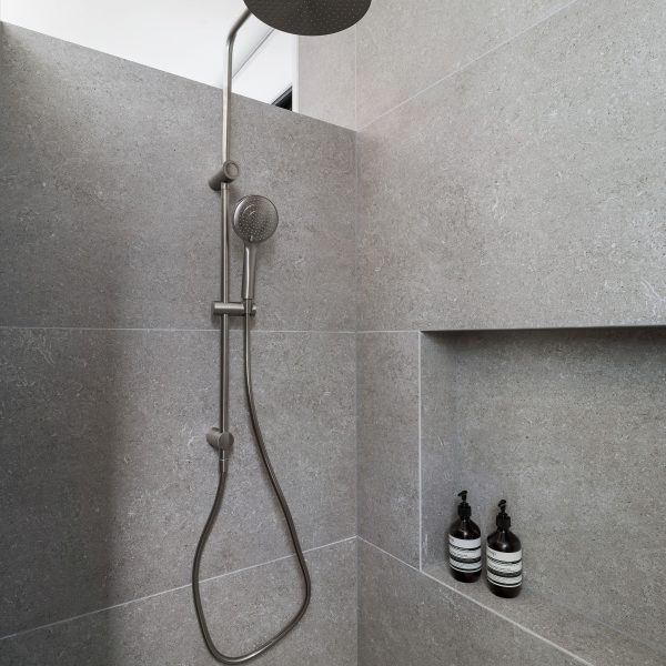 Walk-in shower rainhead detail in Stanwell Park coastal custom home with minimalist architectural finish