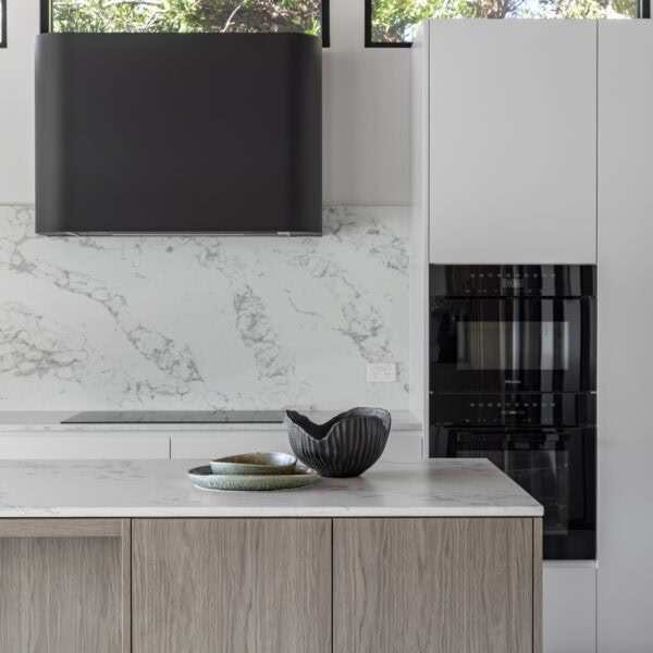 Stone kitchen benchtop and custom joinery detail in the kitchen of Stanwell Park No.3.