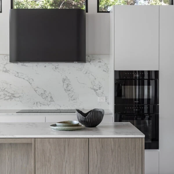 Stone kitchen benchtop and custom joinery detail in the kitchen of Stanwell Park No.3.