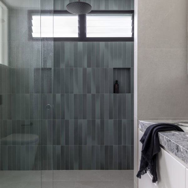Walk-in shower with green feature tiles and frameless glass in Stanwell Park No.3.