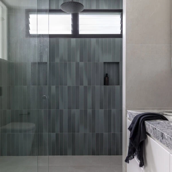 Walk-in shower with green feature tiles and frameless glass in Stanwell Park No.3.
