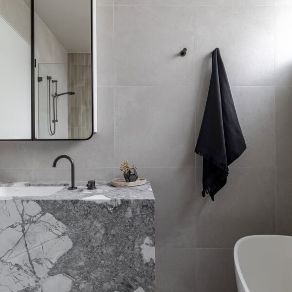 Stone bathroom vanity with custom joinery and black tapware in Stanwell Park No.3.