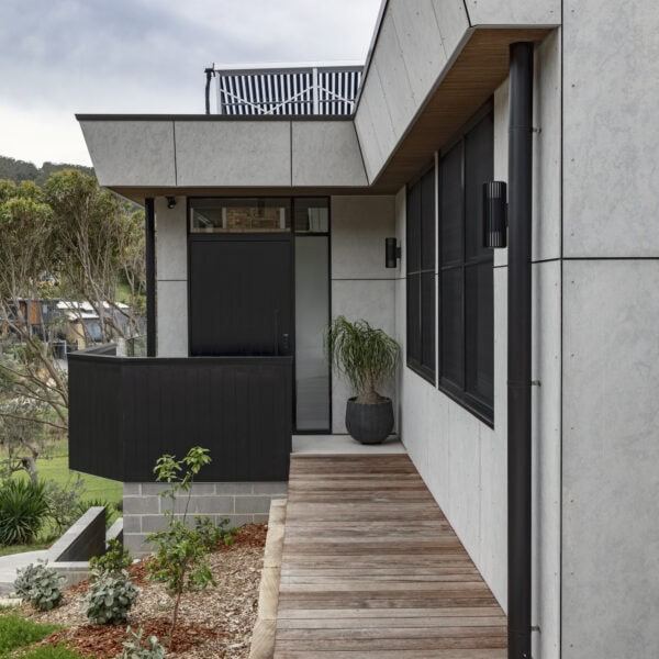 Entry approach to Stanwell Park No.3 showing the front entry, timber walkway and landscaped coastal garden.